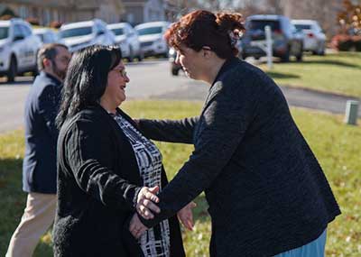 Nancy DeGeorgis and Genise Quinton go in for a hug.