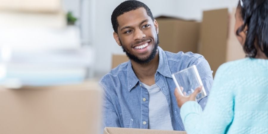 Father and daughter packing glasses for a move