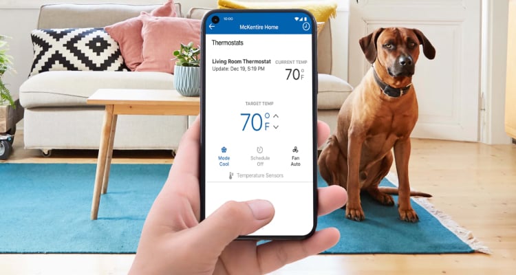 Homeowner adjusting the temperature of their home with the ADT mobile app